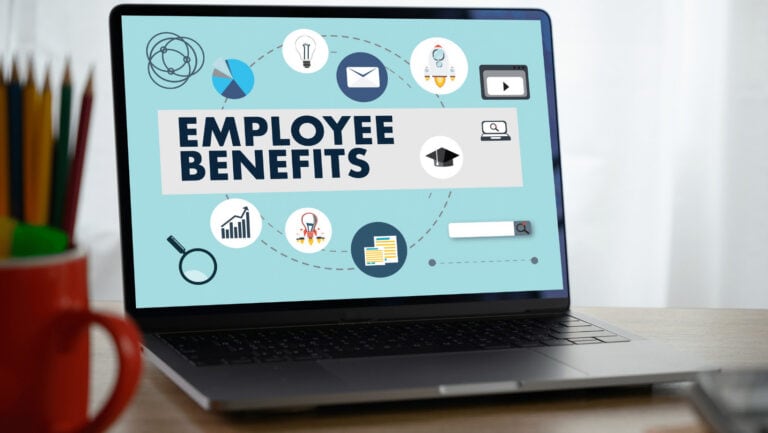 Laptop screen displaying employee benefits icons and text for small business owners.