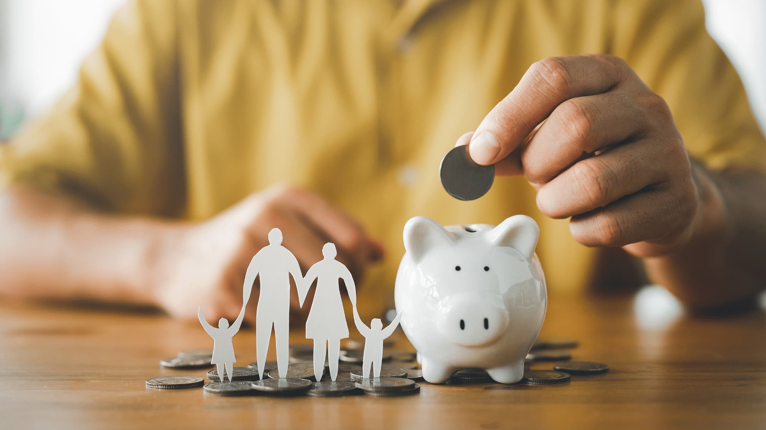 Family saving money for future expenses with piggy bank and coins.